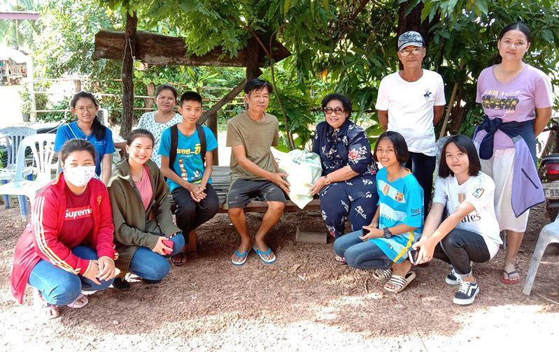 Group photo of smiling people outdoors.