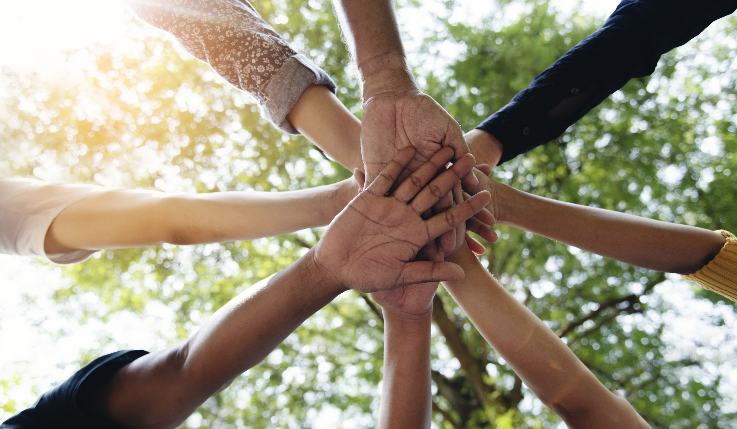 Many people putting their hands together as one.
