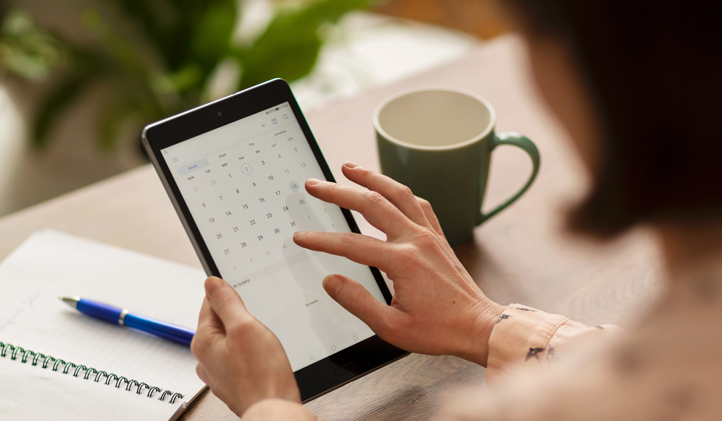 Person checking calendar on tablet