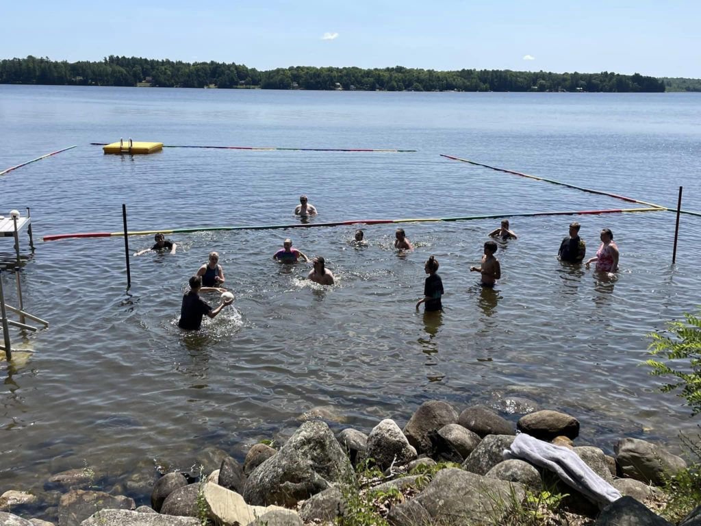 Group playing game in a lake.