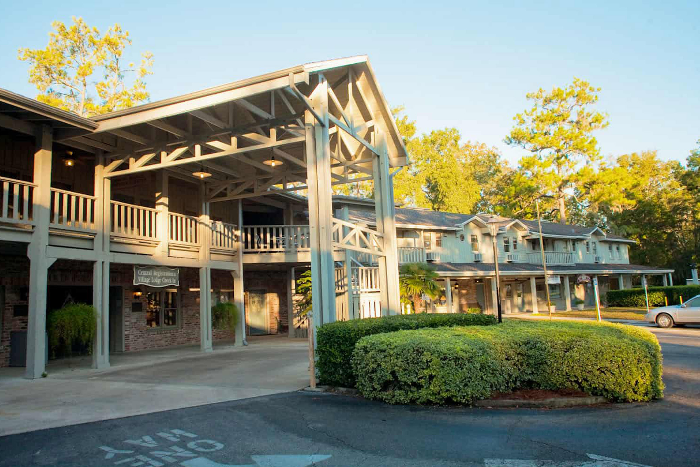 Lodge entrance with parking and greenery