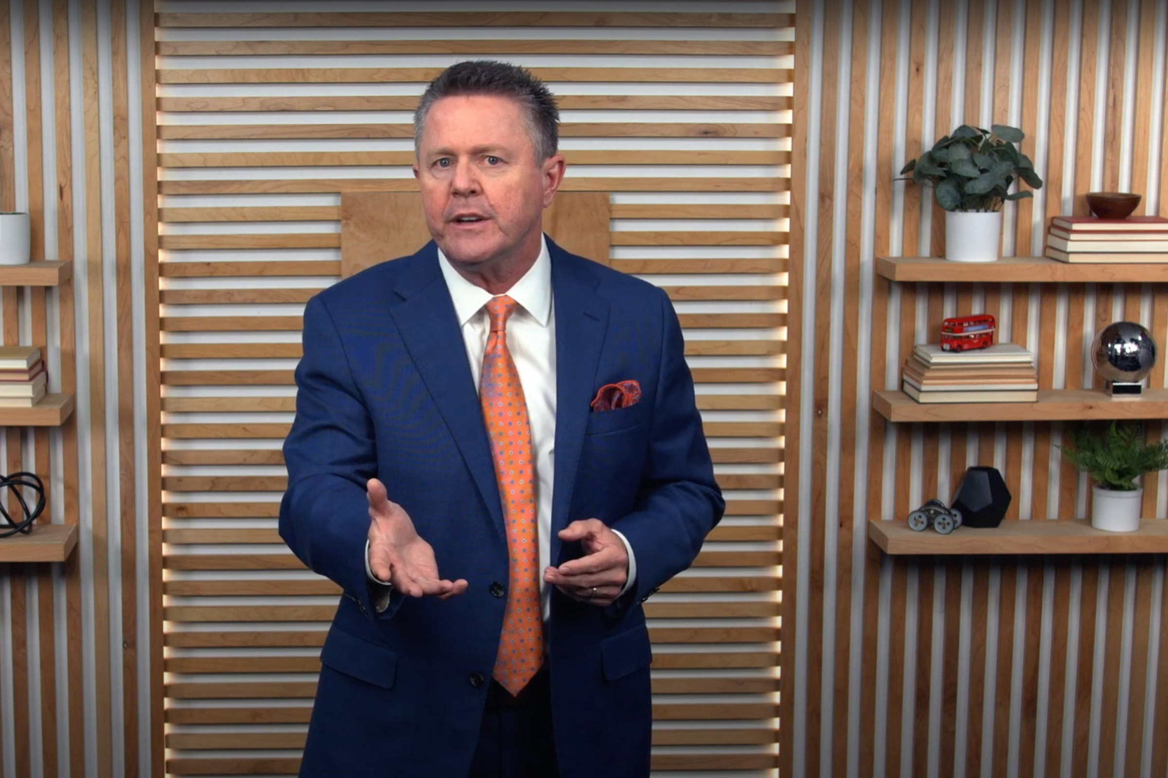 Man in suit giving a presentation.
