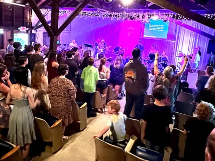 Audience enjoying live music performance in rustic venue.